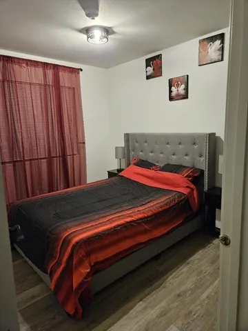 a bedroom with a bed and a window