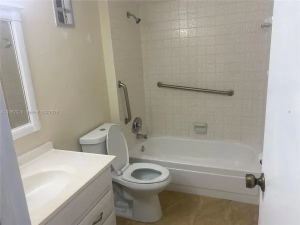 a bathroom with a toilet a sink and bathtub