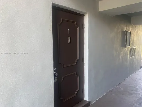 a view of a hallway with wooden cabinets