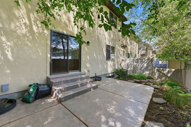 7235 Viansa Court Midvale, UT 84047 - Photo 35 of 43 Entrance to property with stucco siding and a patio