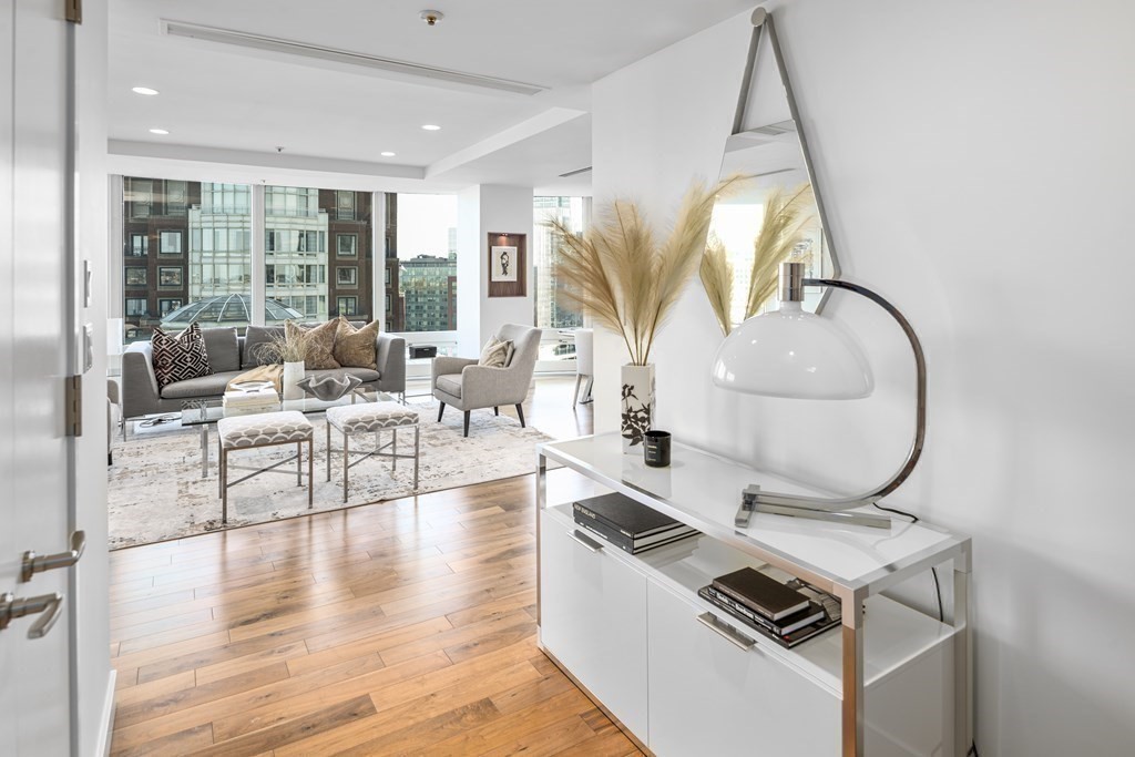 10 Rowes Wharf, Unit PH4 Boston, MA 02110 - Photo 12 of 41 a living room with furniture and a floor to ceiling window