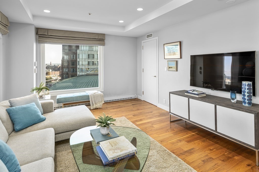 10 Rowes Wharf, Unit PH4 Boston, MA 02110 - Photo 13 of 41 a living room with furniture and a flat screen tv