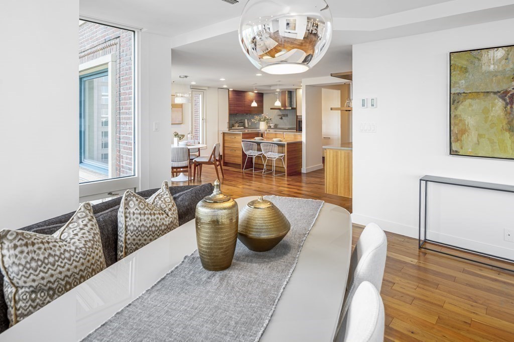 10 Rowes Wharf, Unit PH4 Boston, MA 02110 - Photo 17 of 41 a living room with furniture and a wooden floor
