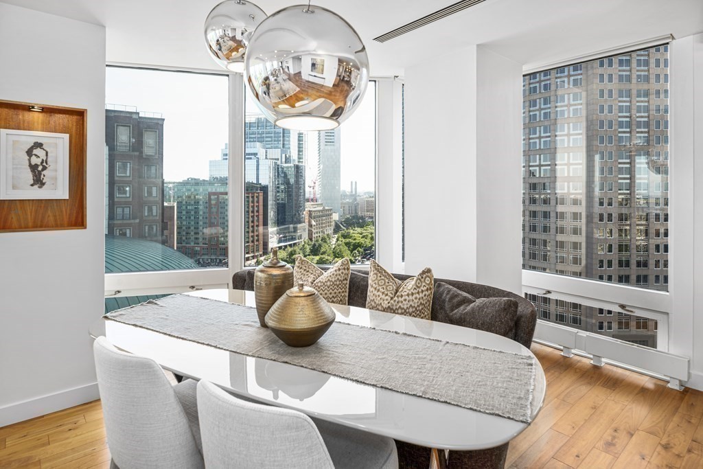 10 Rowes Wharf, Unit PH4 Boston, MA 02110 - Photo 18 of 41 a living room with furniture and a large window