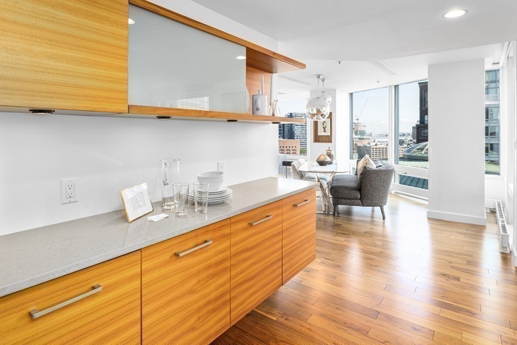 10 Rowes Wharf, Unit PH4 Boston, MA 02110 - Photo 22 of 41 a large living room with stainless steel appliances kitchen island granite countertop wooden floor and cabinets