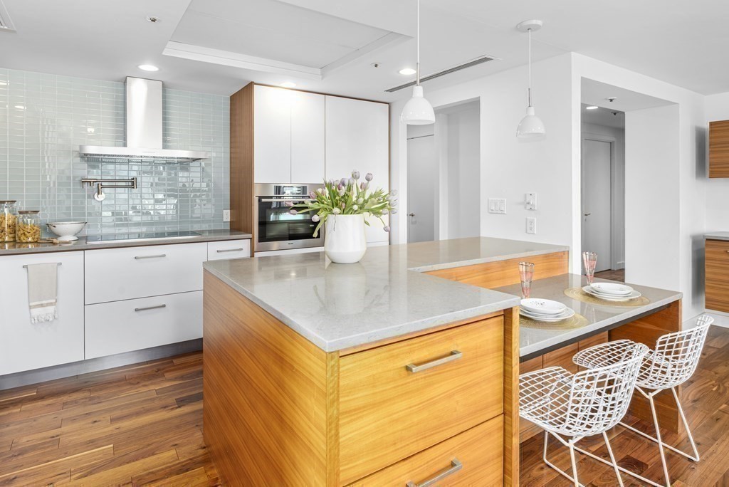 10 Rowes Wharf, Unit PH4 Boston, MA 02110 - Photo 24 of 41 a kitchen with stainless steel appliances granite countertop a sink and cabinets