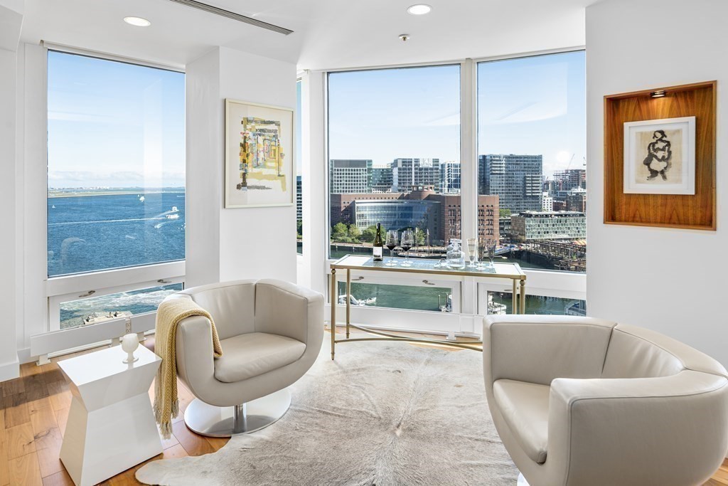 10 Rowes Wharf, Unit PH4 Boston, MA 02110 - Photo 4 of 41 a living room with furniture and a large window