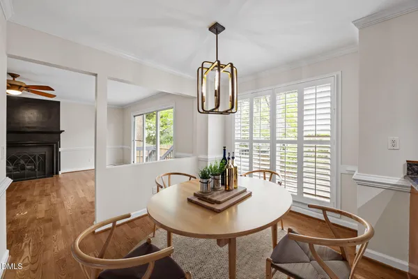 a kitchen with stainless steel appliances granite countertop a stove a sink dishwasher and a refrigerator with wooden floor