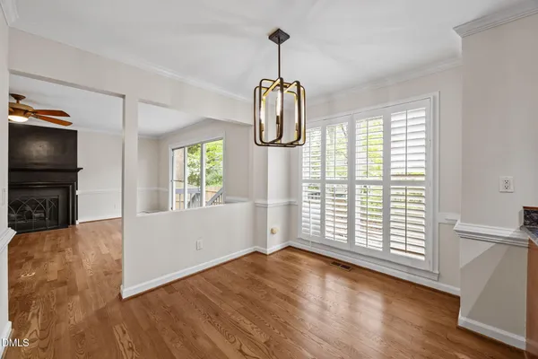 a living room with furniture a window and a chandelier
