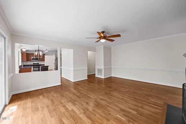 a living room with furniture and view of kitchen