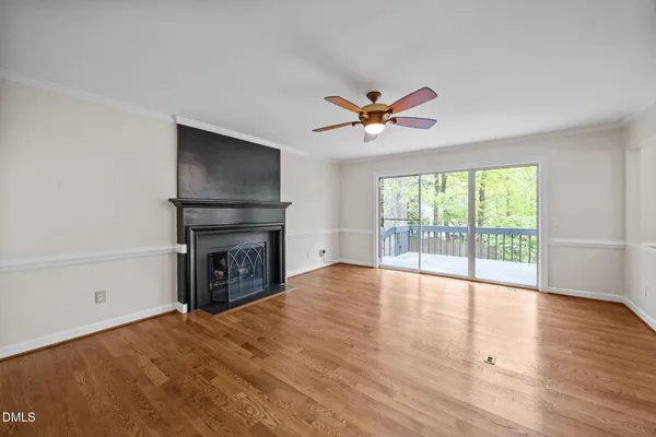 a living room with furniture a fireplace and a floor to ceiling window