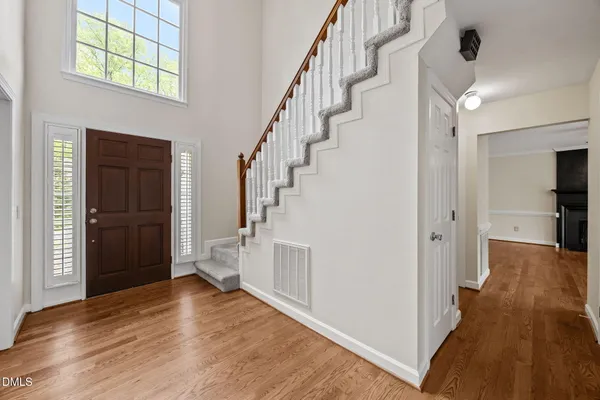 a view of empty room with a fireplace and wooden floor