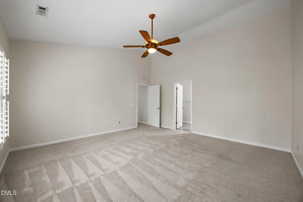 a bedroom with a bed chandelier and a window