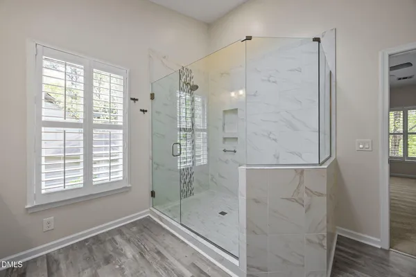 a large bathroom with a double vanity sink a large mirror and shower