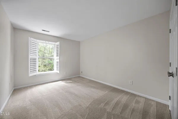 a bedroom with bed and a window