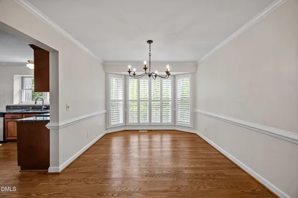a dining room with furniture window and wooden floor