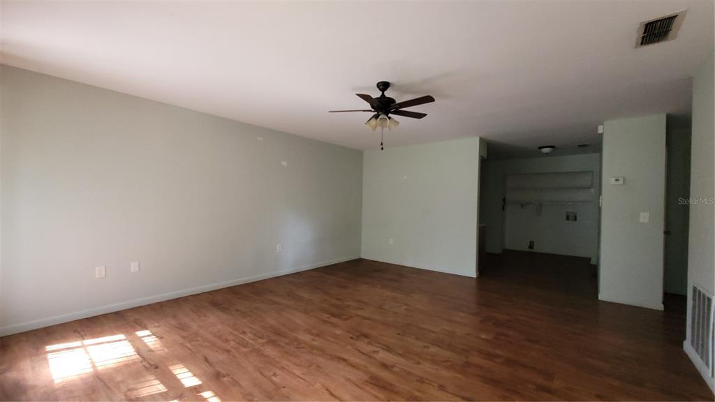 7119 Southwest 45th Place, Unit A Gainesville, FL 32608 - Photo 5 of 12 wooden floor in an empty room