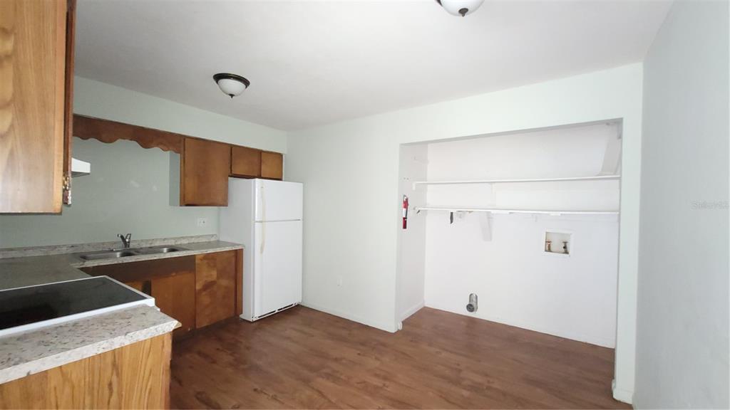 7119 Southwest 45th Place, Unit A Gainesville, FL 32608 - Photo 6 of 12 a kitchen with a sink a stove and cabinets
