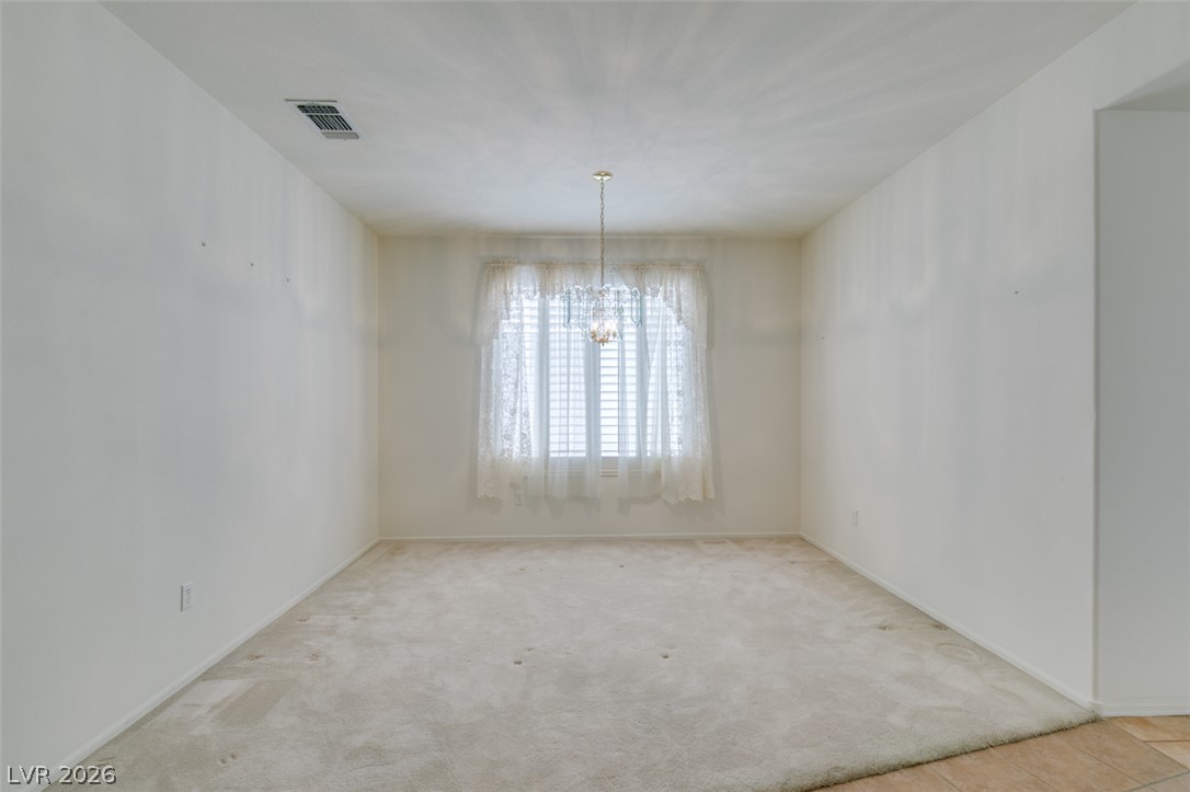 2189 Chapman Ranch Drive Henderson, NV 89012 - Photo 12 of 60 A spacious formal dining room awaits under a classic chandelier fixture.