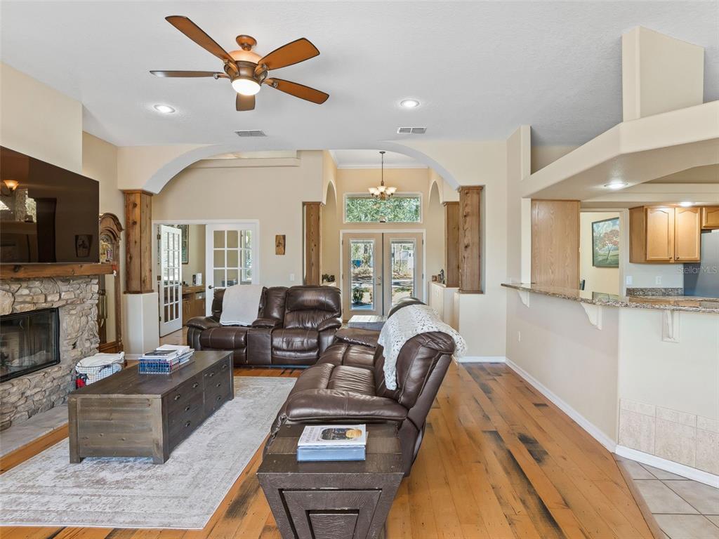 11670 Southeast 6th Street Williston, FL 32696 - Photo 11 of 63 a living room with furniture a fireplace and a flat screen tv
