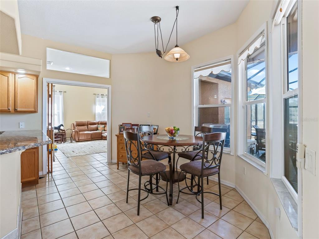 11670 Southeast 6th Street Williston, FL 32696 - Photo 13 of 63 a view of a dining room with furniture and a chandelier
