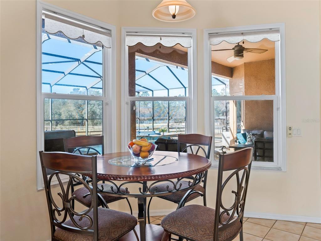 11670 Southeast 6th Street Williston, FL 32696 - Photo 14 of 63 a dining room with furniture a chandelier and wooden floor