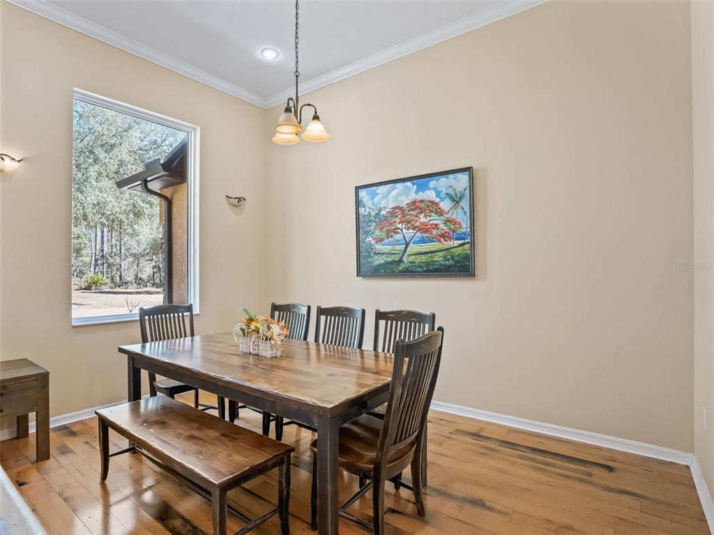 11670 Southeast 6th Street Williston, FL 32696 - Photo 18 of 63 a view of a dining room with furniture window and wooden floor