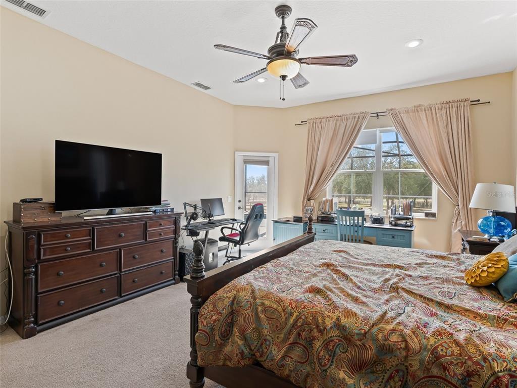 11670 Southeast 6th Street Williston, FL 32696 - Photo 21 of 63 a bedroom with a bed and a flat screen tv