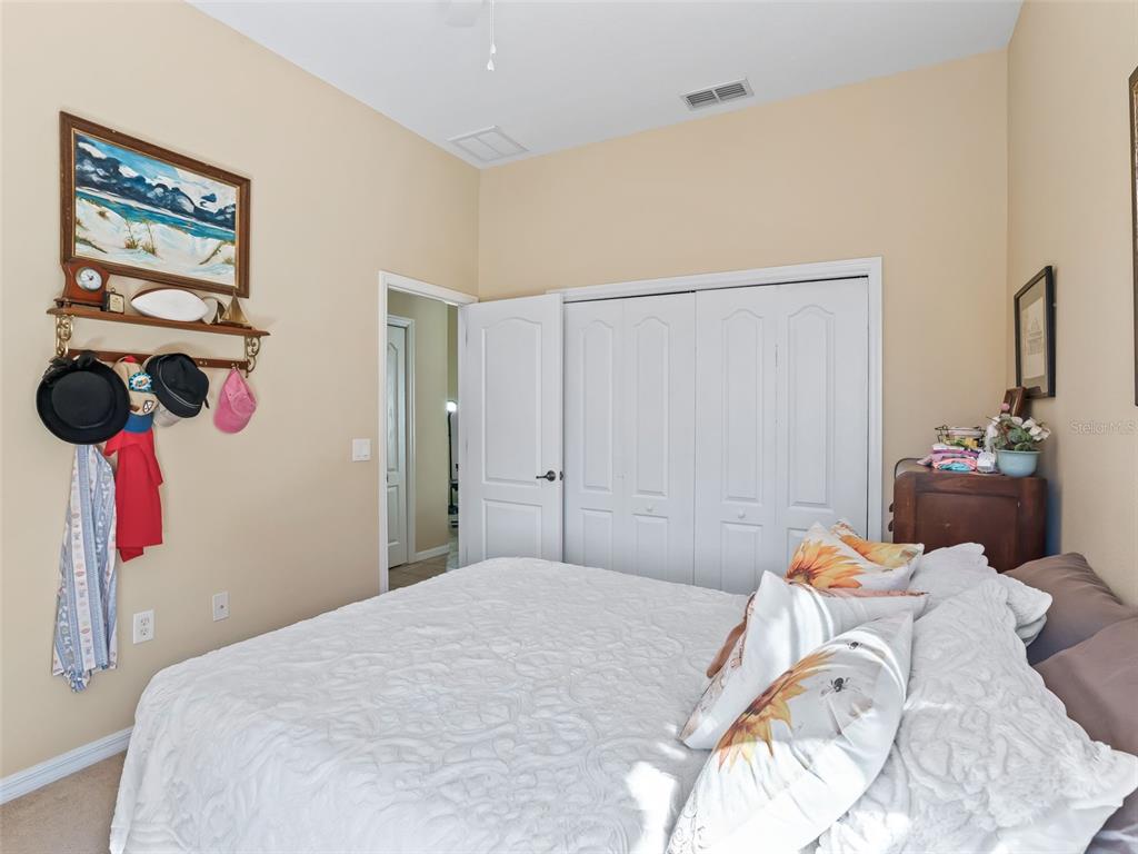 11670 Southeast 6th Street Williston, FL 32696 - Photo 30 of 63 a bedroom with a bed and the painting on the wall