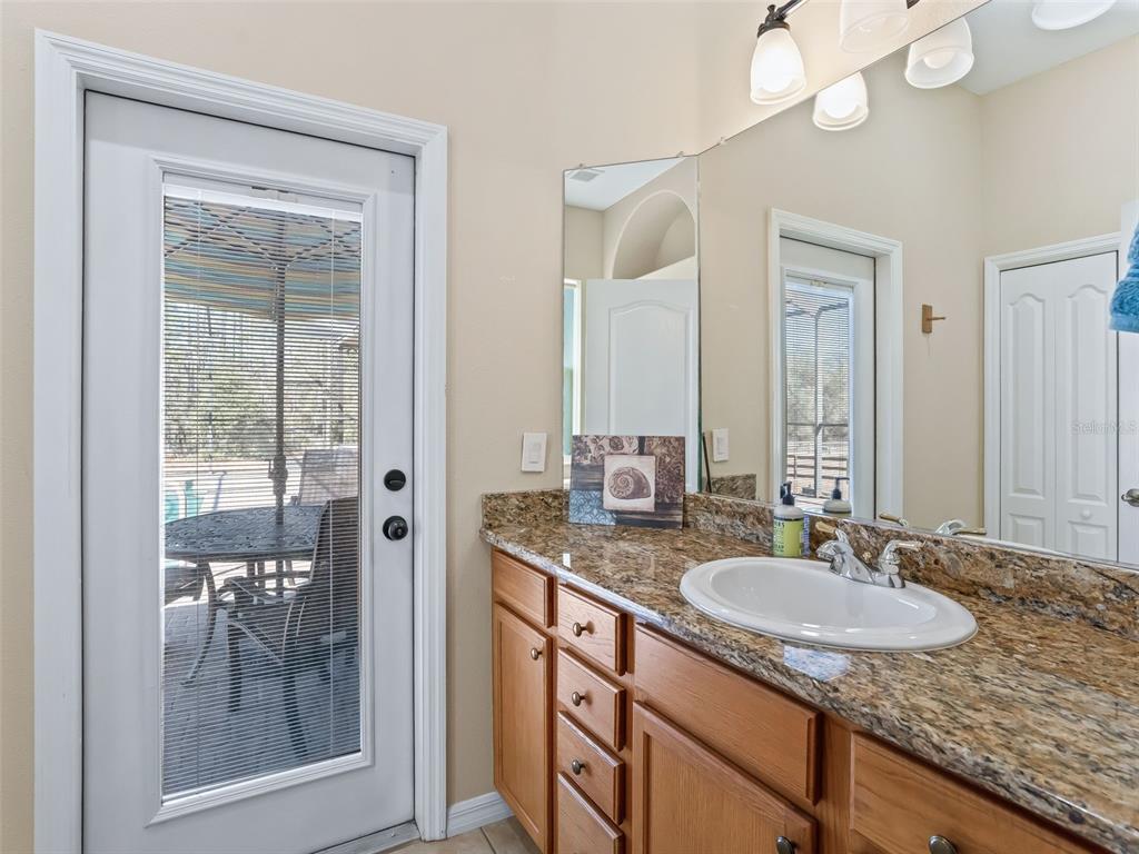 11670 Southeast 6th Street Williston, FL 32696 - Photo 31 of 63 a bathroom with sinks granite countertop a sink and a mirror
