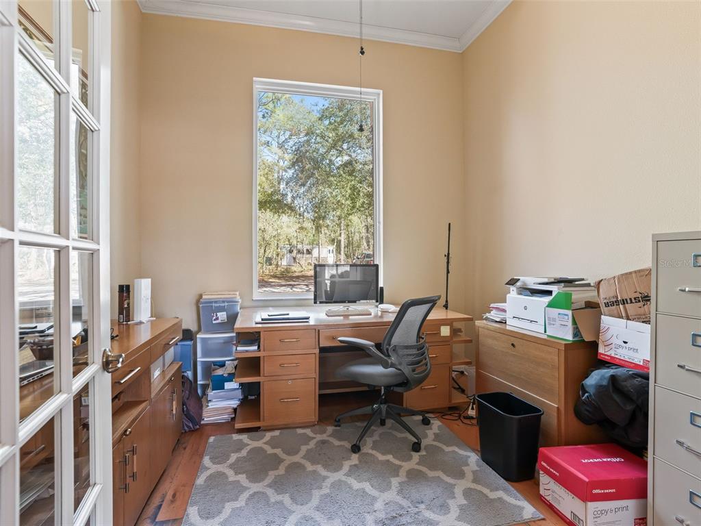 11670 Southeast 6th Street Williston, FL 32696 - Photo 33 of 63 a room with furniture a bed and a window