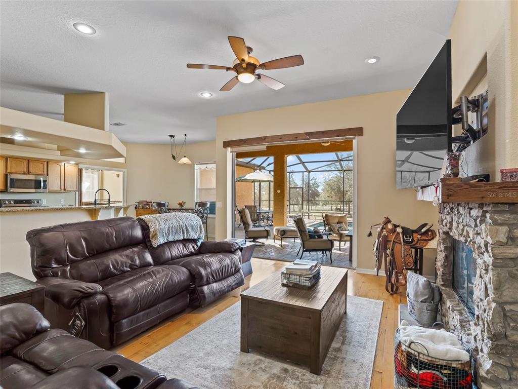 11670 Southeast 6th Street Williston, FL 32696 - Photo 8 of 63 a living room with furniture ceiling fan and a rug
