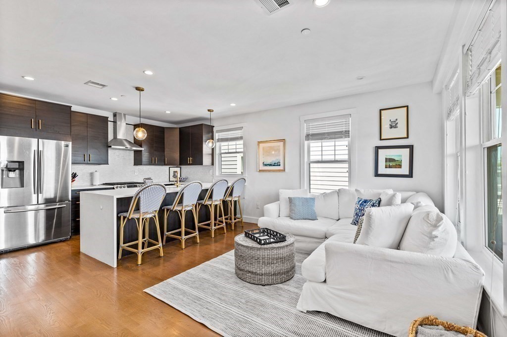 a living room with furniture and kitchen view