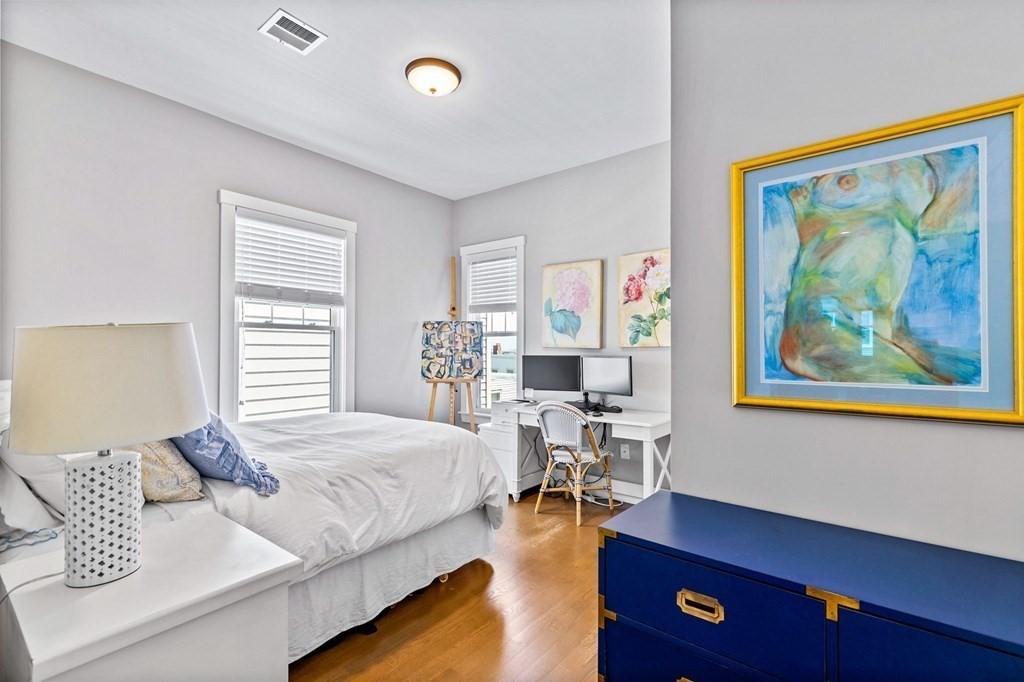 241 Lexington Street, Unit 2 Boston, MA 02128 - Photo 11 of 21 a bedroom with a bed and wooden floor