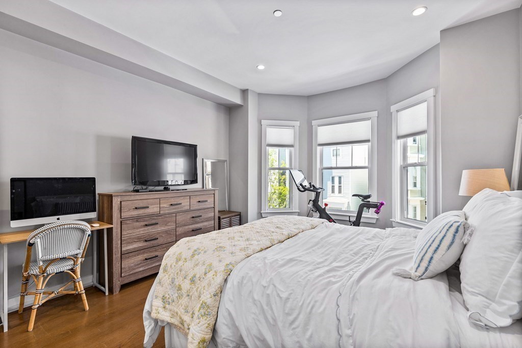 241 Lexington Street, Unit 2 Boston, MA 02128 - Photo 17 of 21 a bedroom with a bed and a flat screen tv