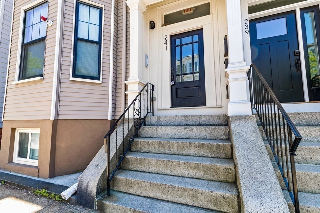 241 Lexington Street, Unit 2 Boston, MA 02128 - Photo 19 of 21 a view of staircase with lots of frames on wall and windows