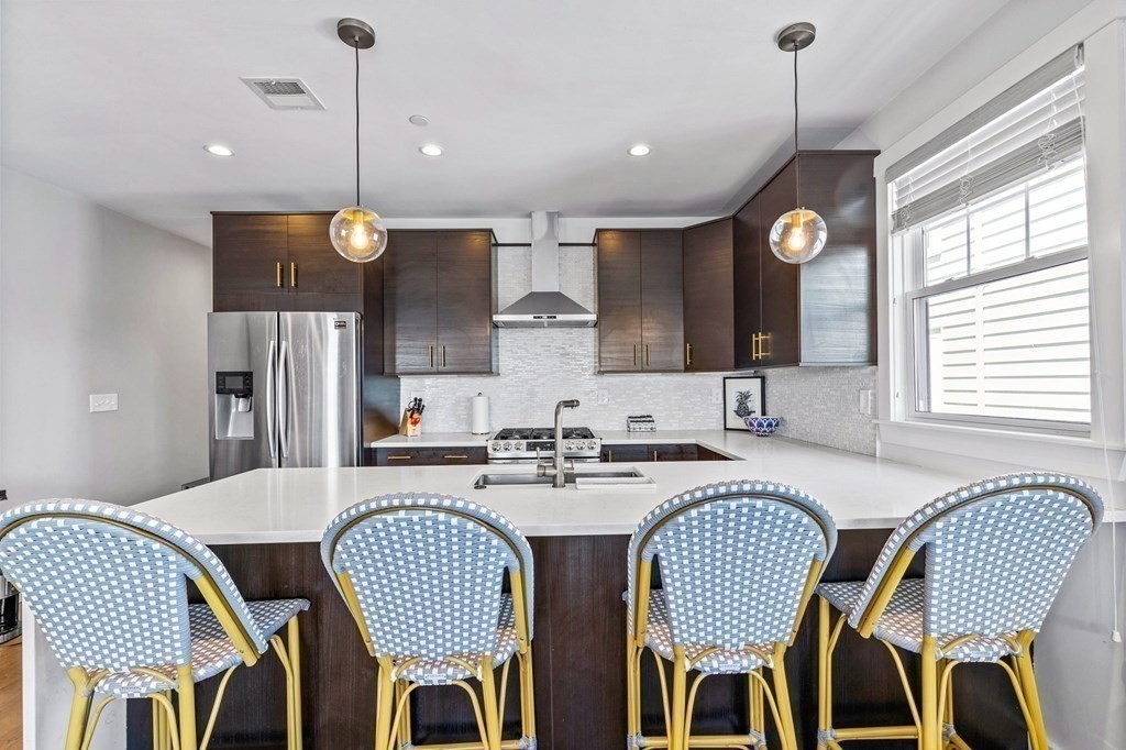 241 Lexington Street, Unit 2 Boston, MA 02128 - Photo 3 of 21 a kitchen with a dining table chairs and microwave