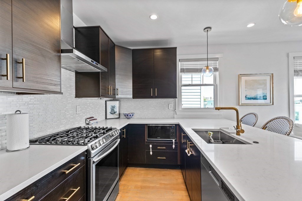 241 Lexington Street, Unit 2 Boston, MA 02128 - Photo 4 of 21 a kitchen that has a sink and a stove