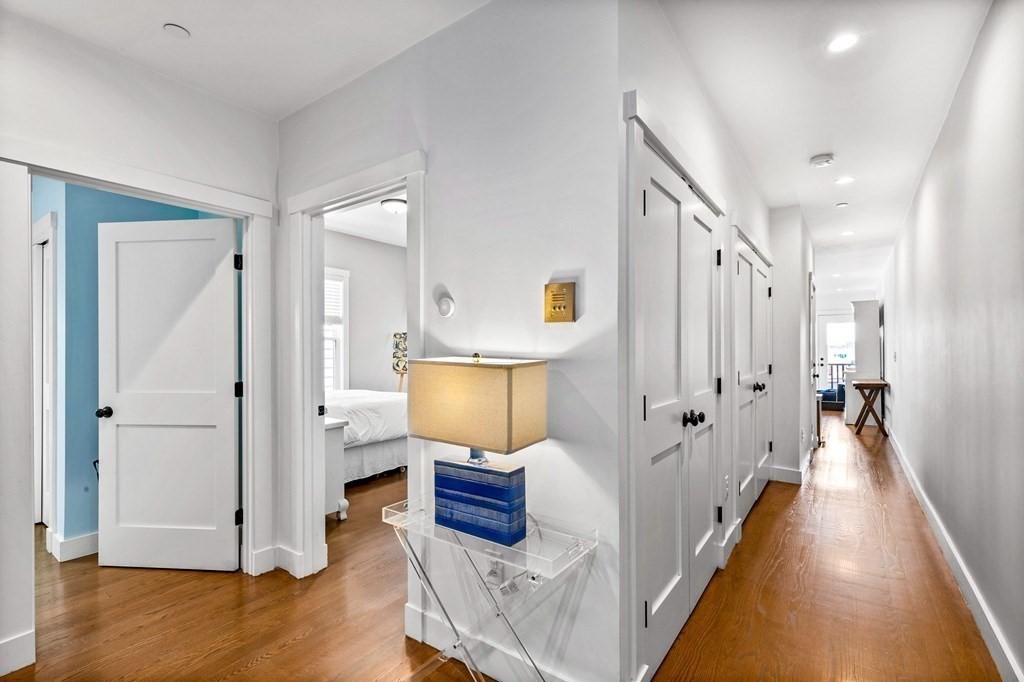 241 Lexington Street, Unit 2 Boston, MA 02128 - Photo 10 of 21 a view of a hallway with wooden floor and cabinet