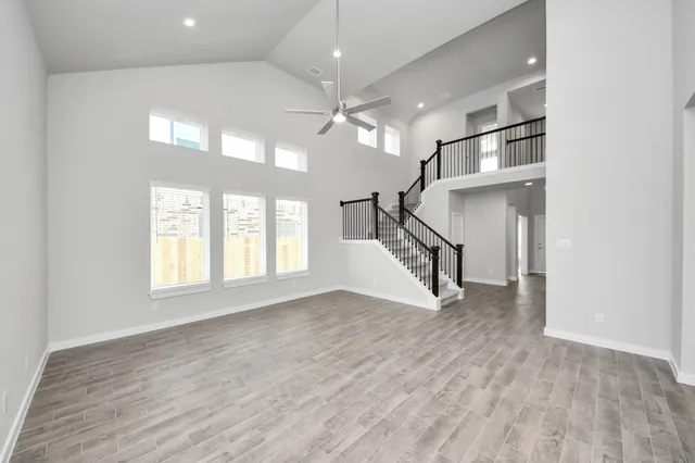 a view of a room with wooden floor and windows