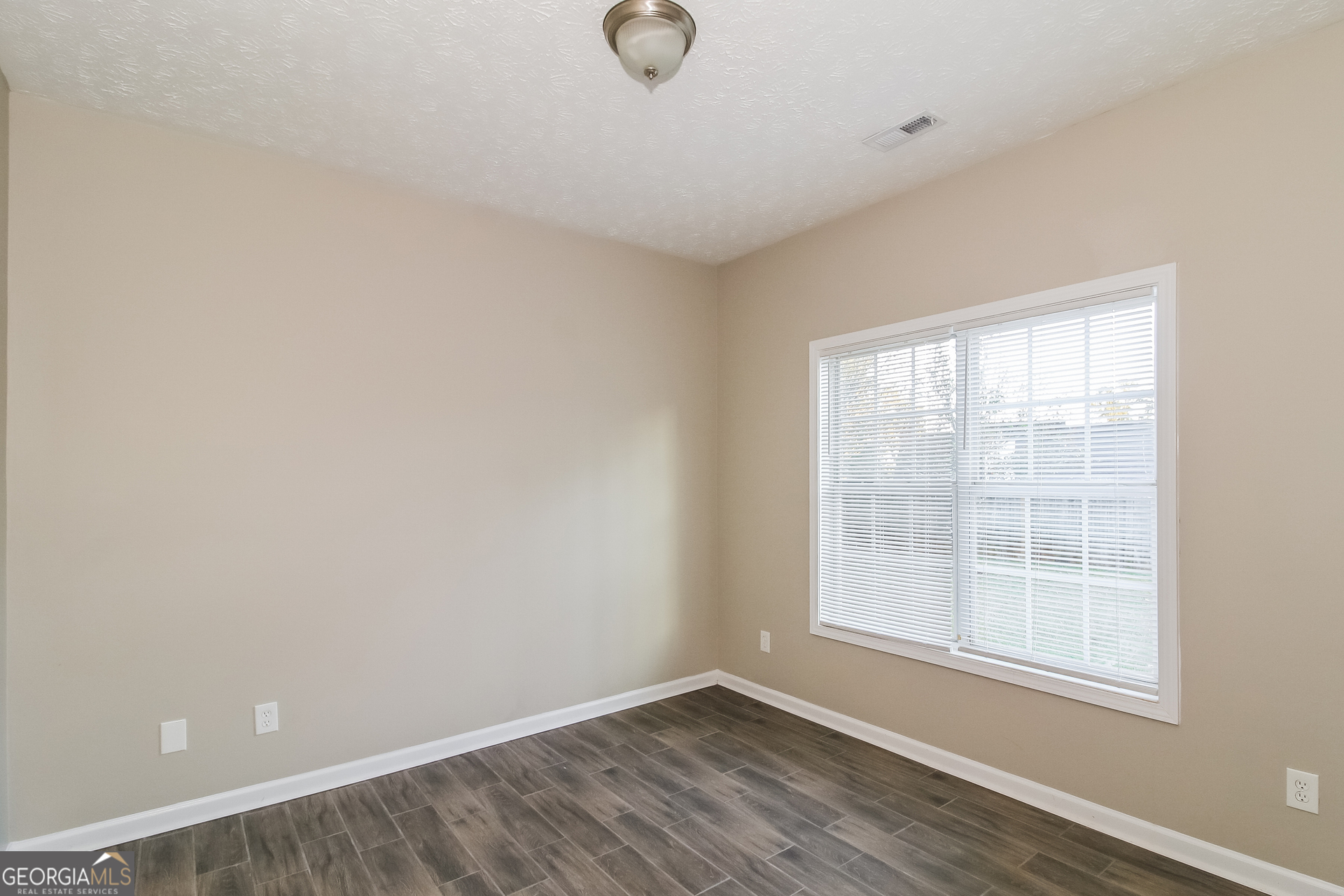 3399 Bells Landing Drive Rex, GA 30273 - Photo 11 of 16 an empty room with wooden floor and windows