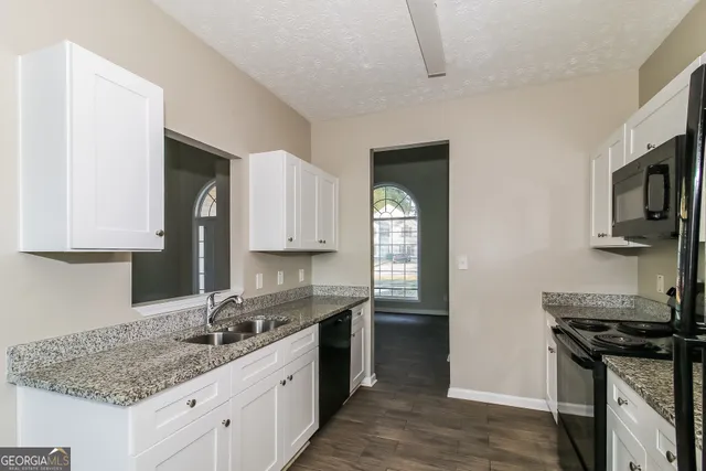 a kitchen with a sink stove and cabinets