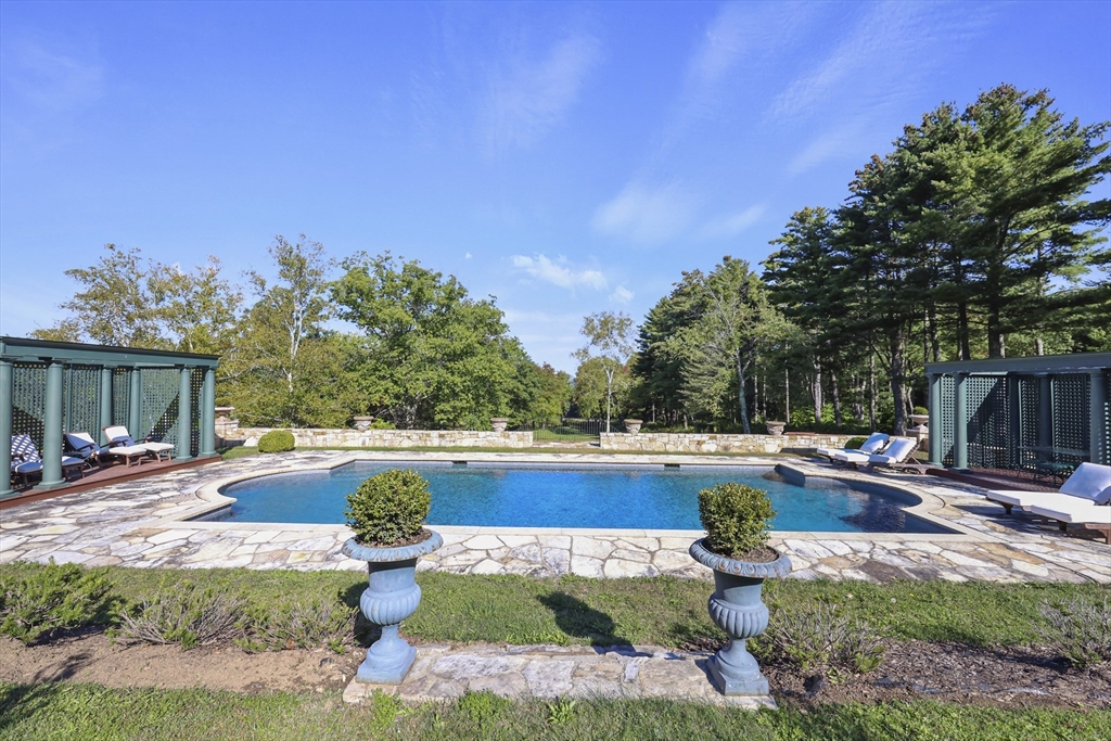 209 Blue Hill Road Great Barrington, MA 01230 - Photo 28 of 42 a view of swimming pool with lawn chairs and plants