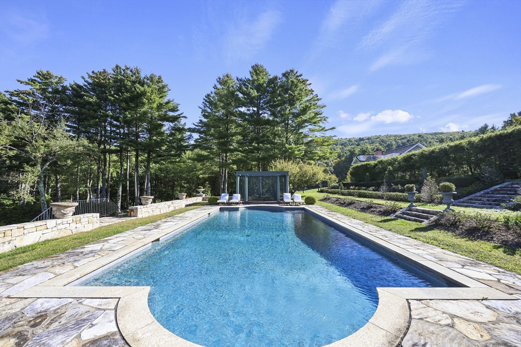 209 Blue Hill Road Great Barrington, MA 01230 - Photo 29 of 42 a view of a swimming pool with a chair and tables