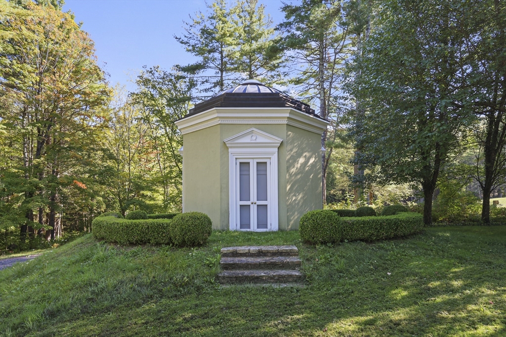 209 Blue Hill Road Great Barrington, MA 01230 - Photo 30 of 42 a front view of a house with garden