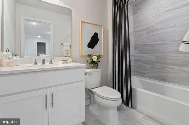 a bathroom with a toilet a sink a tub and mirror