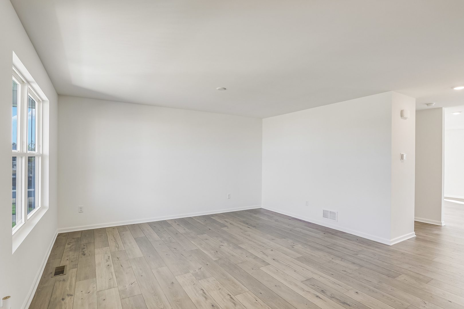 512 Endicott Road South Elgin, IL 60177 - Photo 4 of 30 an empty room with wooden floor and windows
