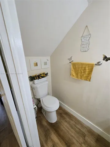 a bathroom with a toilet and a shower curtain