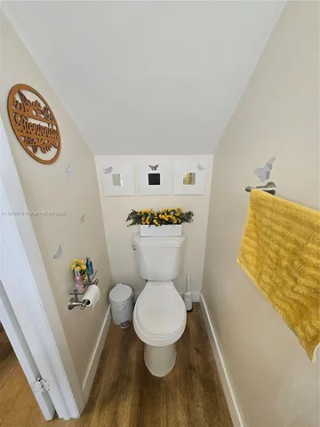 a white toilet sitting next to a bathroom sink