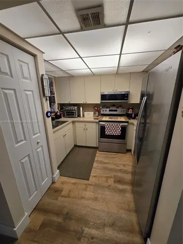 a kitchen with refrigerator and stove